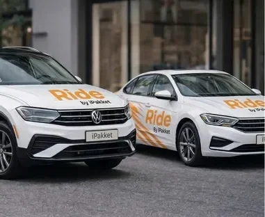 Two Ride by iPakket carsharing vehicles parked side by side on a city street